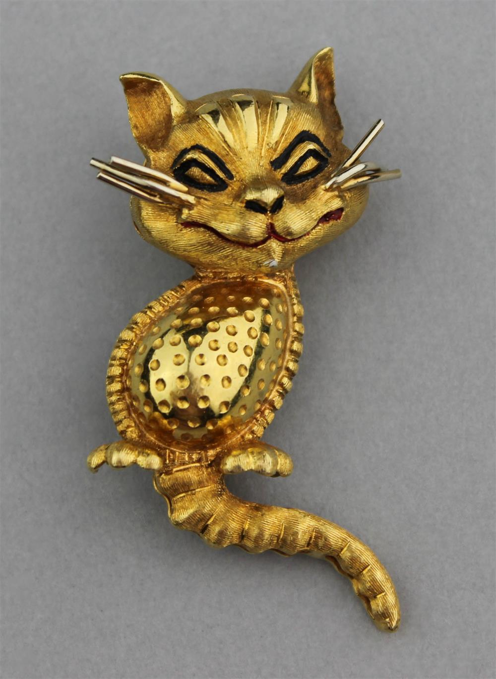 Appraisal: K YELLOW GOLD AND ENAMELED CHESHIRE CAT BROOCH stamped K