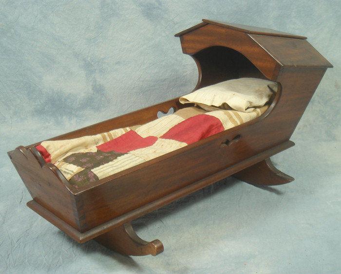 Appraisal: Dovetailed mahogany doll size hooded cradle with quilt and pillow