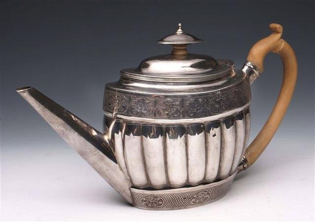 Appraisal: A GEORGE III SILVER TEA POT oval shaped with fluted