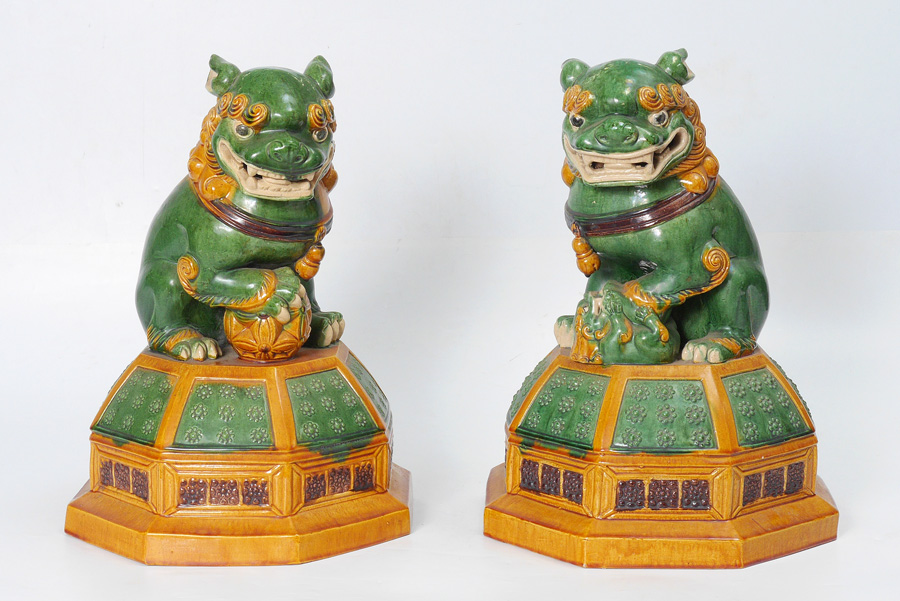 Appraisal: PAIR CHINESE EARTHENWARE FOO LIONS Green yellow and brown glaze