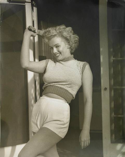 Appraisal: A Marilyn Monroe over-sized sepia photograph by Andre de Dienes