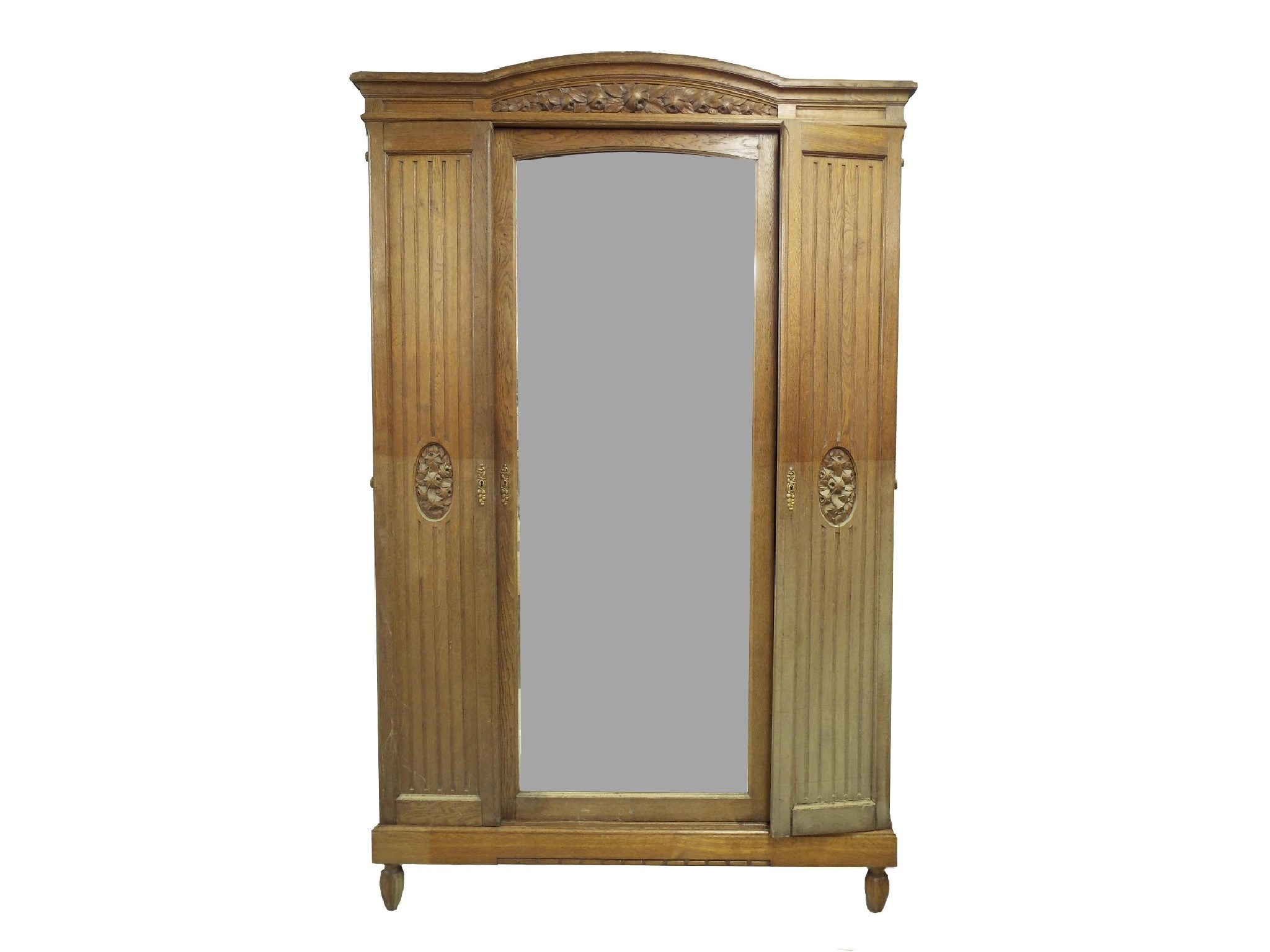 Appraisal: French oak armoire the arched top and carved floral pediment