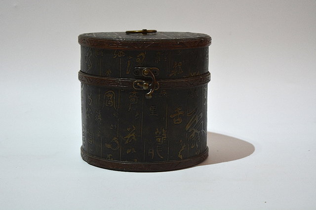 Appraisal: A Chinese leather boxof cylindrical form with character decoration containing