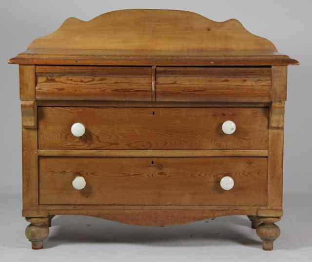 Appraisal: A Victorian pine chest with shaped splash back over two