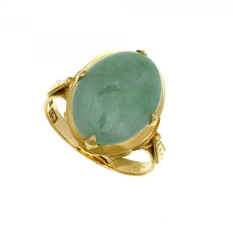 Appraisal: A JADE RING the oval cabochon on gold hoop marked