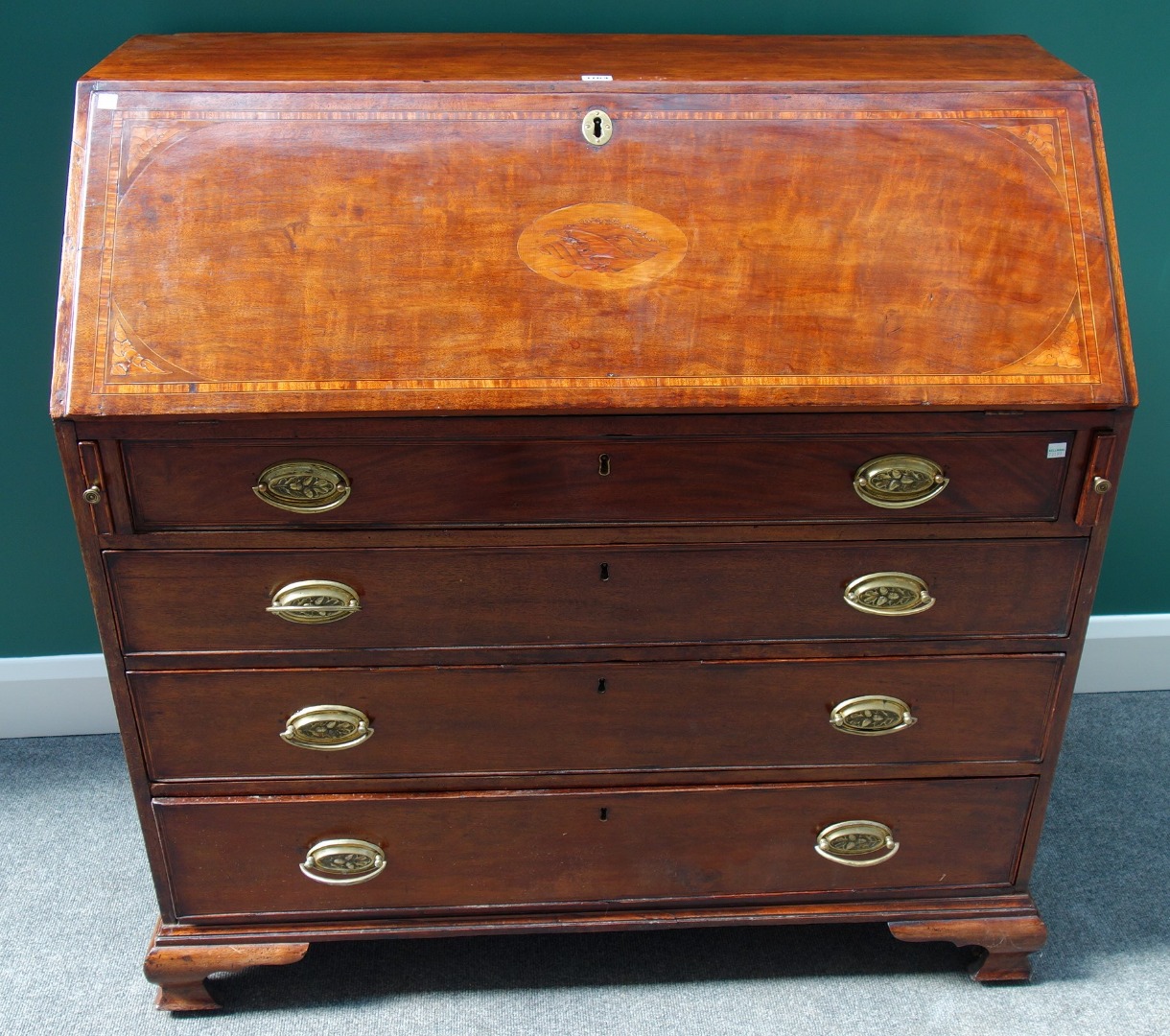 Appraisal: A George III inlaid mahogany bureau the fall enclosing a