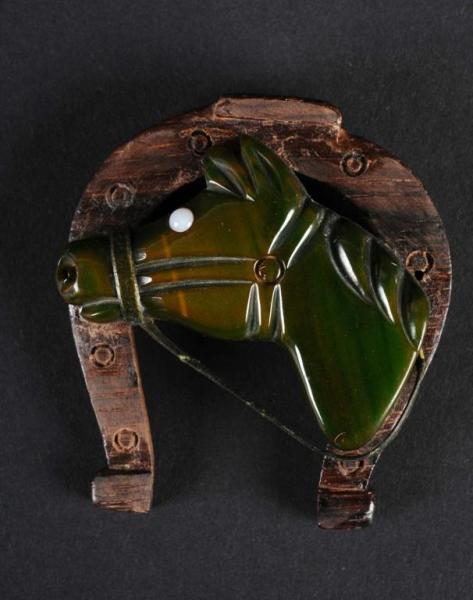 Appraisal: Bakelite Green Horse Head Pin Description With white glass eye