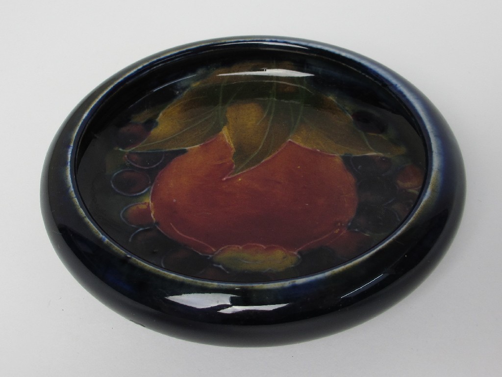 Appraisal: A Moorcroft dish decorated with pomegranate and berries impressed and