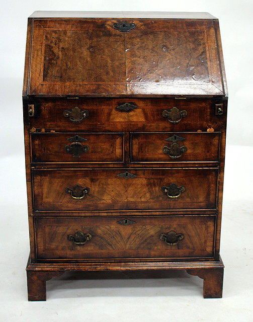 Appraisal: A GEORGIAN STYLE WALNUT BUREAU the fall front enclosing a