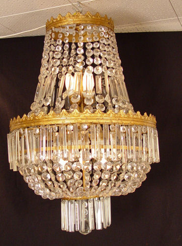 Appraisal: EMPIRE STYLE CRYSTAL CHANDELIER Nine light bar and chain prisms