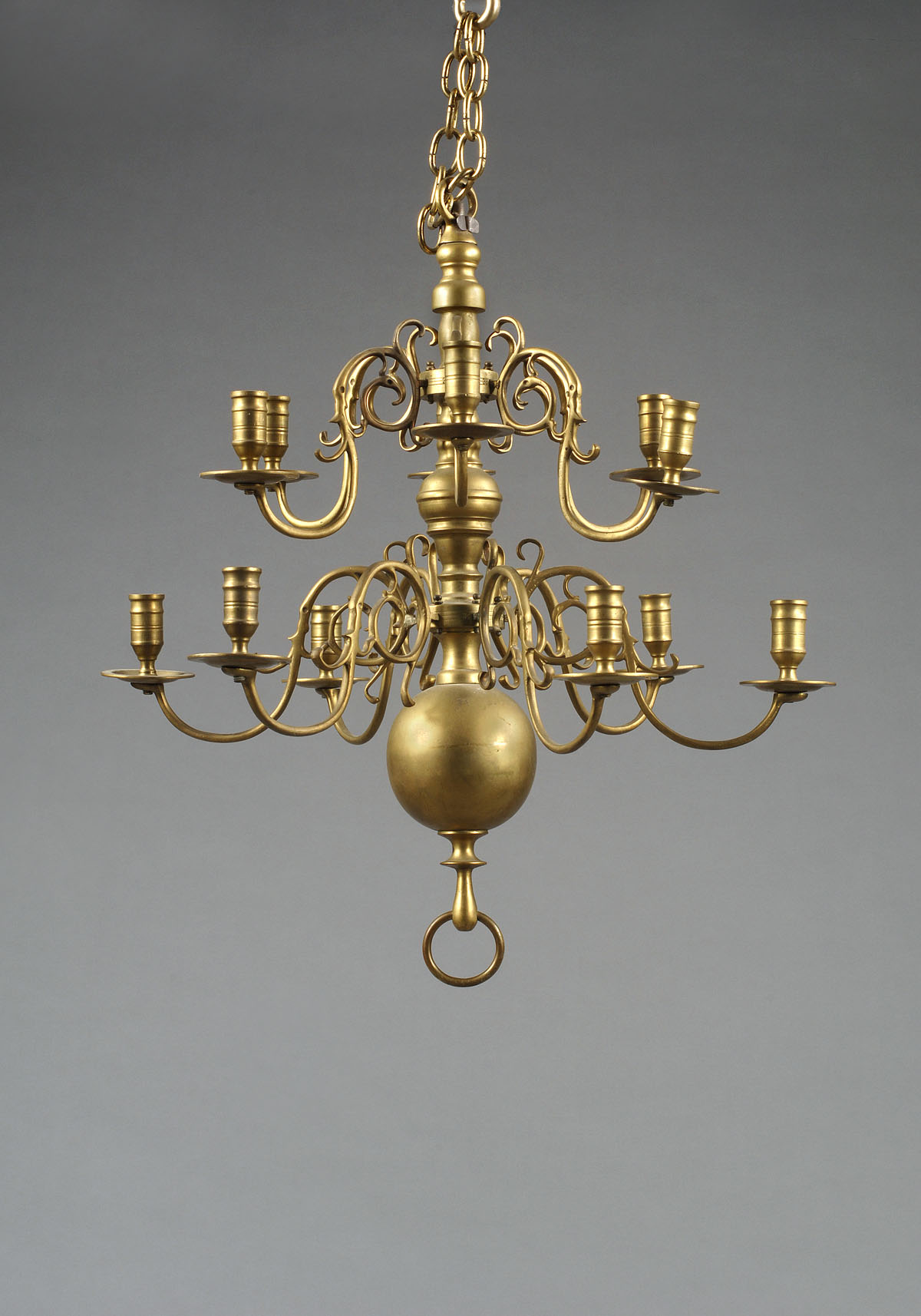 Appraisal: DUTCH BRASS TWO-TIER FOURTEEN-LIGHT CHANDELIER The baluster standard issuing scrolling