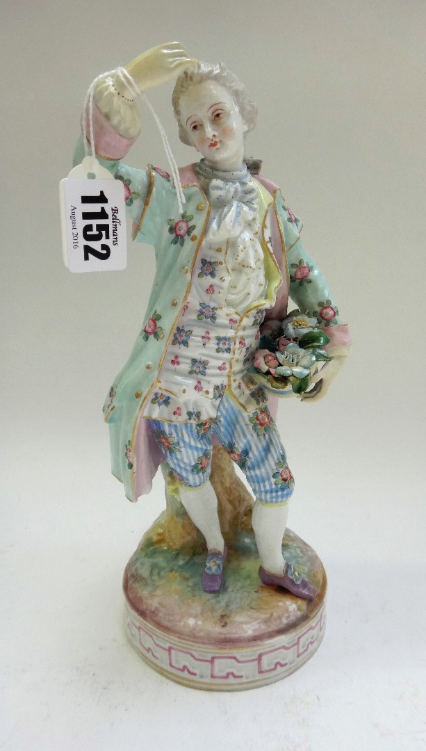 Appraisal: A German porcelain figure modelled as a dandy holding a