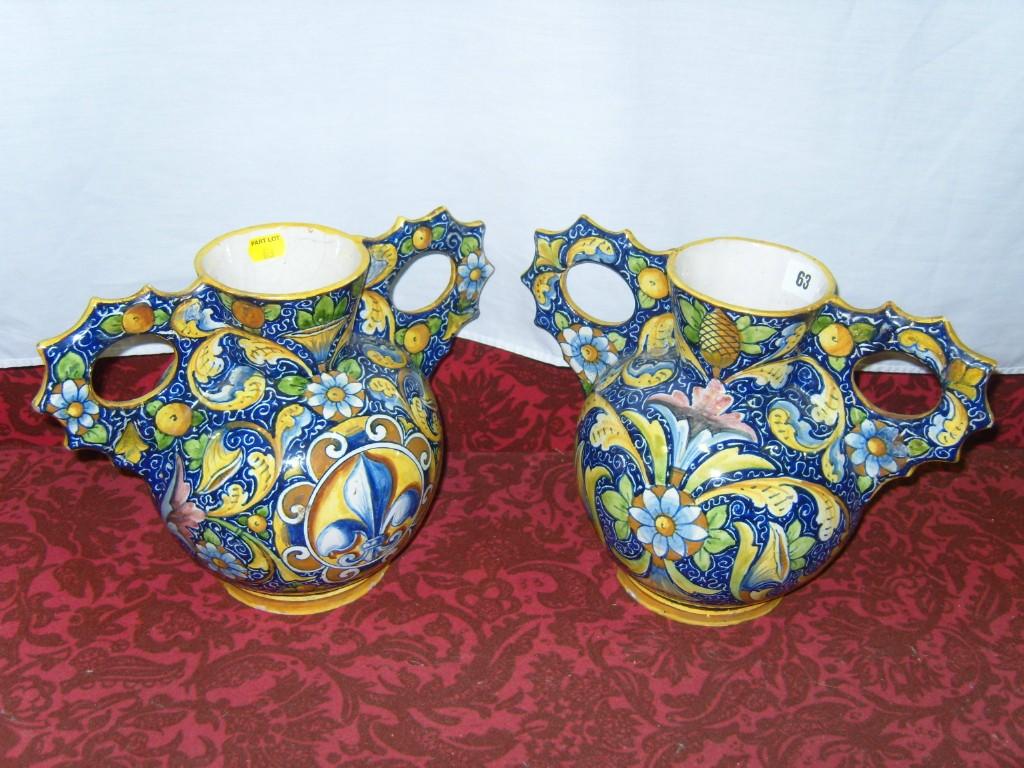 Appraisal: A pair of continental tin glazed earthenware -handled vases with