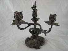 Appraisal: A bronze two light candelabrum in naturalistic form the nozzles