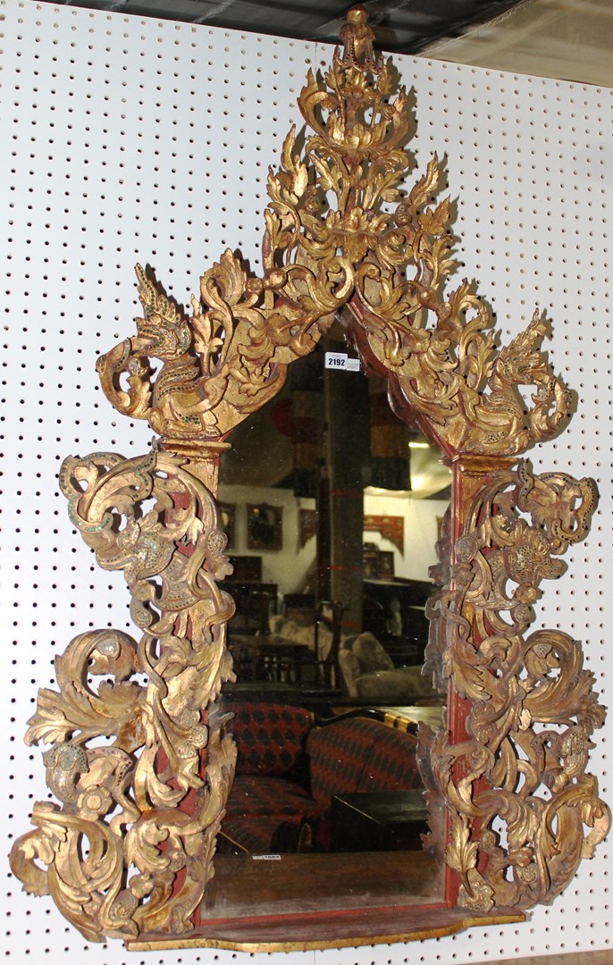 Appraisal: A th century coloured glass inset gilt framed wall mirror