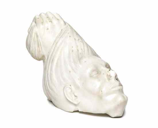 Appraisal: A Continental Marble Sculpture carved as a decapitated head being