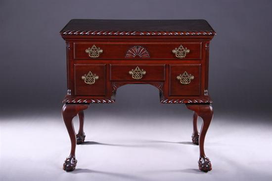 Appraisal: GEORGIAN STYLE CARVED MAHOGANY LOW BOY th century Boldly gadrooned