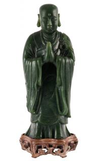 Appraisal: A DARK GREEN JADE CARVING OF ANANDA QING DYNASTY -