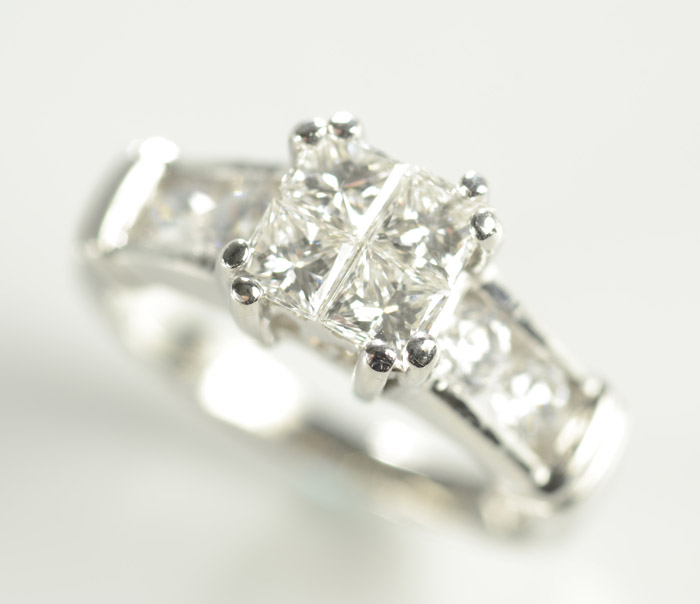 Appraisal: DIAMOND AND PLATINUM RING set with four princess-cut diamonds and