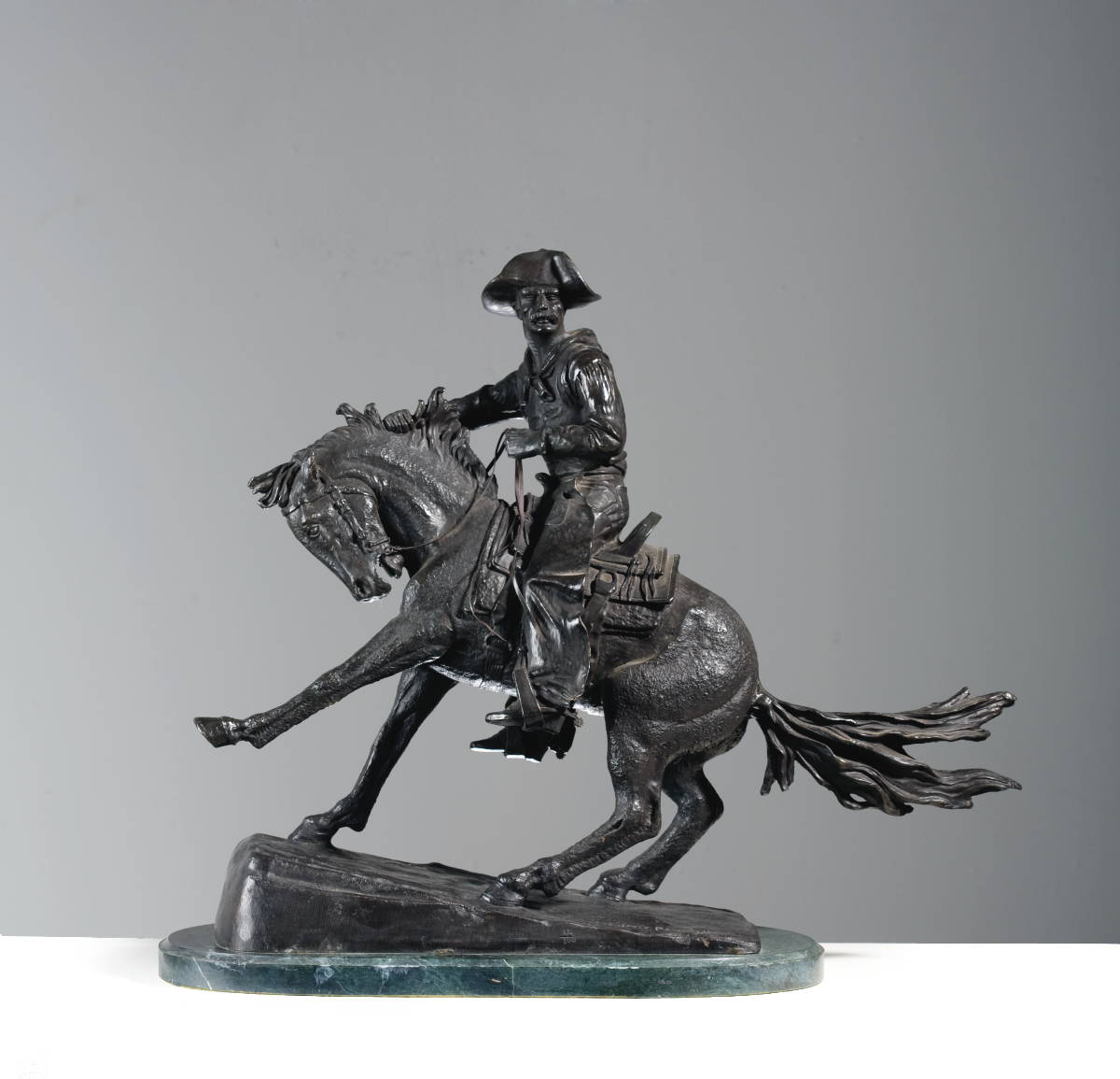 Appraisal: BRONZE FIGURE OF quot THE COWBOY quot AFTER FREDERIC REMINGTON