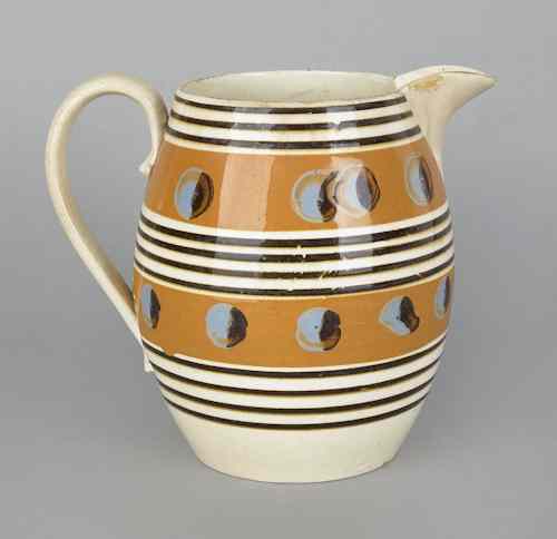 Appraisal: Mocha pitcher th c with cat's-eye decoration on orange bands