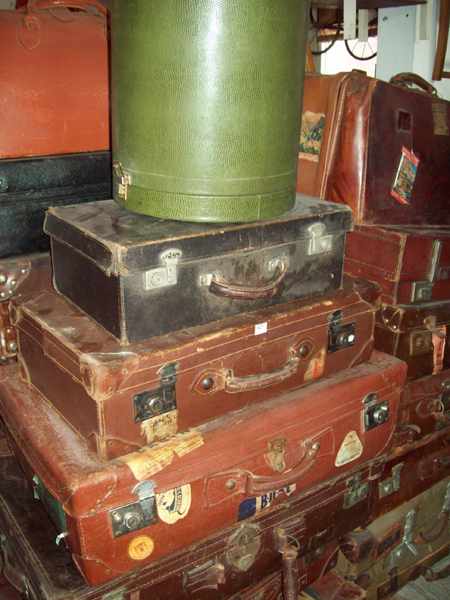 Appraisal: A COLLECTION OF SIX LEATHER SUITCASES AND ONE GREEN WIG