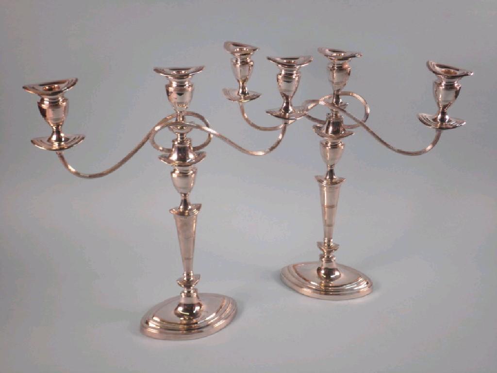 Appraisal: A pair of silver plated three branch candelabrum each with