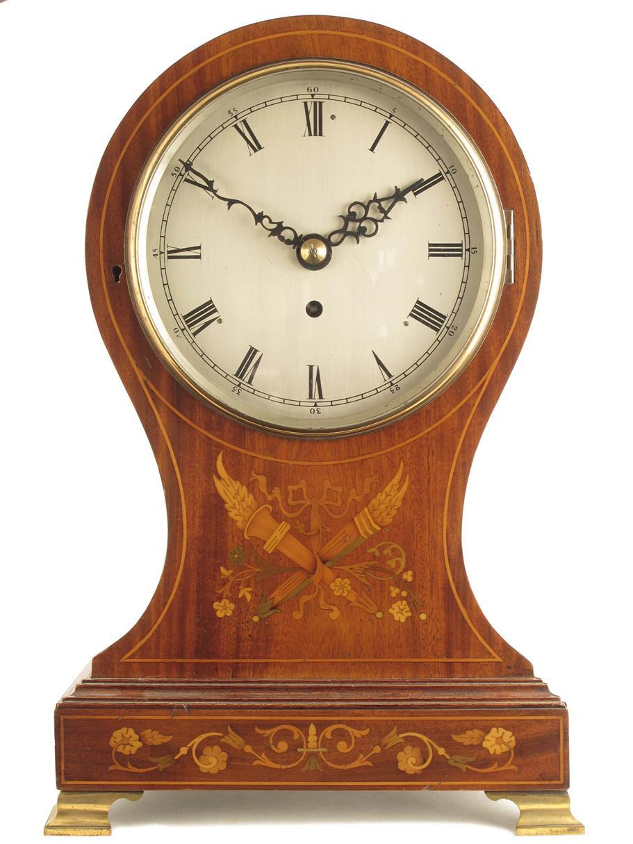 Appraisal: A mahogany and marquetry balloon cased mantel timepiece