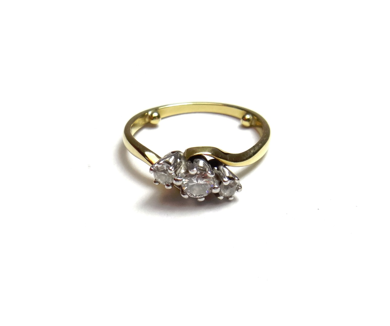 Appraisal: A gold and diamond set three stone ring claw set