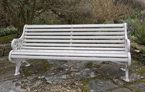 Appraisal: A late th Century scroll back garden slatted bench cm