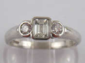 Appraisal: A platinum three stone diamond ring the central rectangular diamond