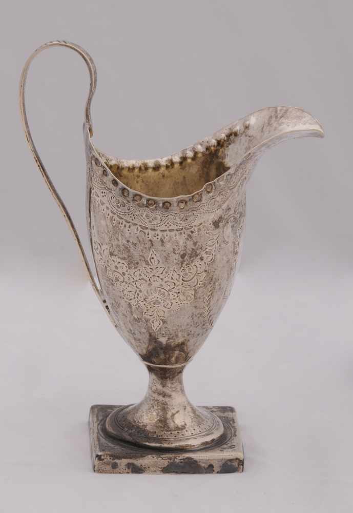 Appraisal: GEORGE III SILVER HELMET-FORM CREAMER Hester Bateman London the rim