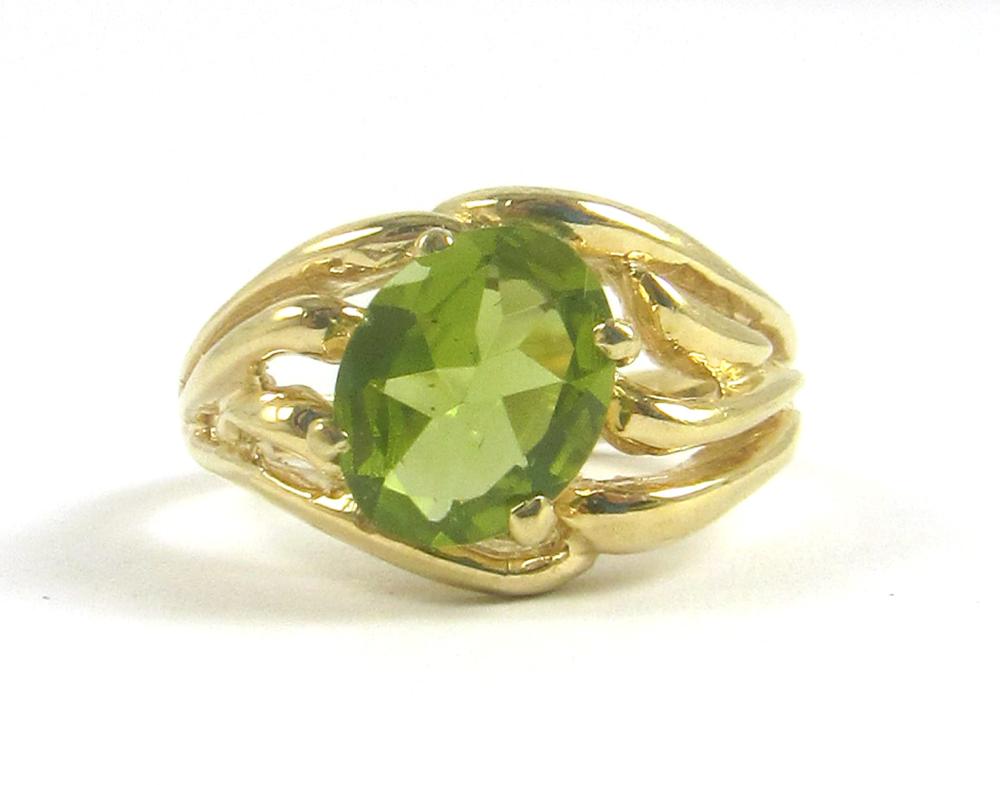 Appraisal: PERIDOT AND FOURTEEN KARAT GOLD SOLITAIRE RING with four yellow