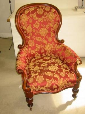 Appraisal: A VICTORIAN MAHOGANY ARM CHAIR of spoon back form upholstered