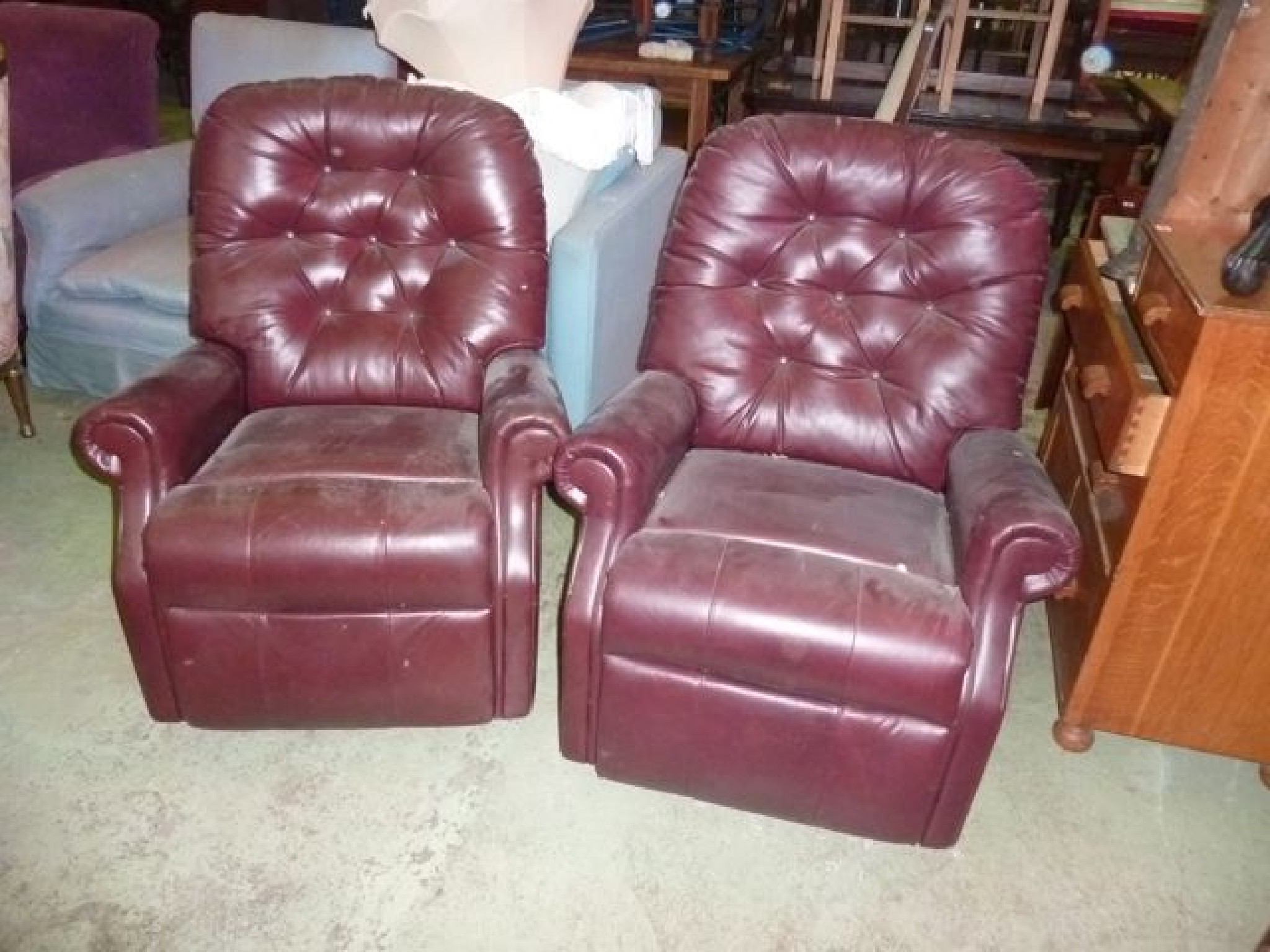 Appraisal: A pair of contemporary burgundy leather upholster armchairs with buttoned