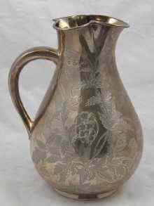 Appraisal: A Victorian silver water jug with engraved decoration in the