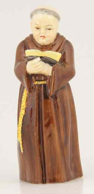 Appraisal: A Royal Worcester candle snuffer Monk with Bible cm high