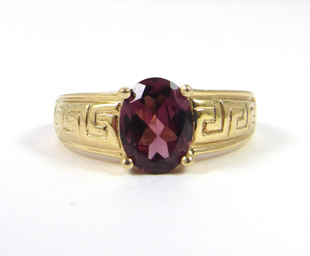 Appraisal: RHODOLITE GARNET AND FOURTEEN KARAT GOLD RING set with an