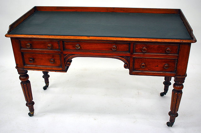 Appraisal: AN EARLY VICTORIAN MAHOGANY FIVE DRAWER WRITING TABLE with green