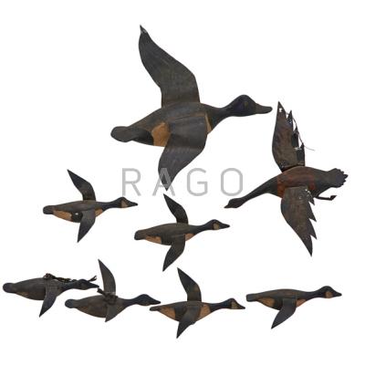 Appraisal: AMERICAN MINIATURE FLYING DUCKS Eight in carved wood with tin