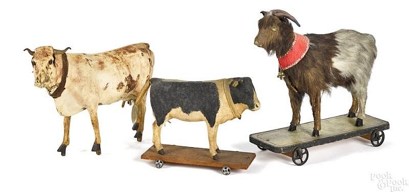 Appraisal: Two composition cow platform pull toys Two composition cow platform