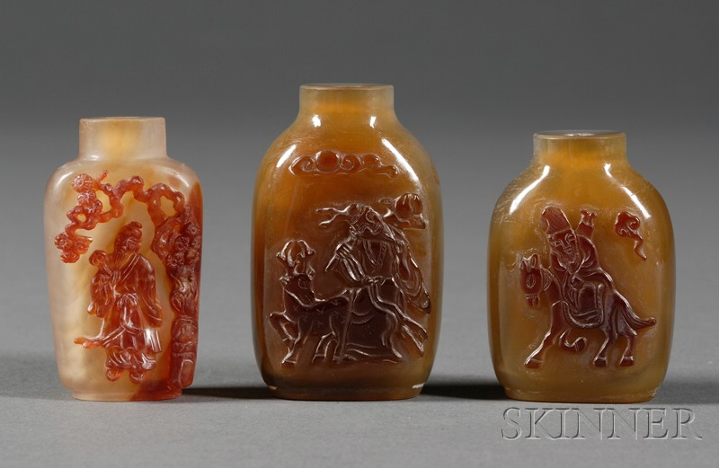 Appraisal: Three Shadow Agate Snuff Bottles surfaces carved with scenes of