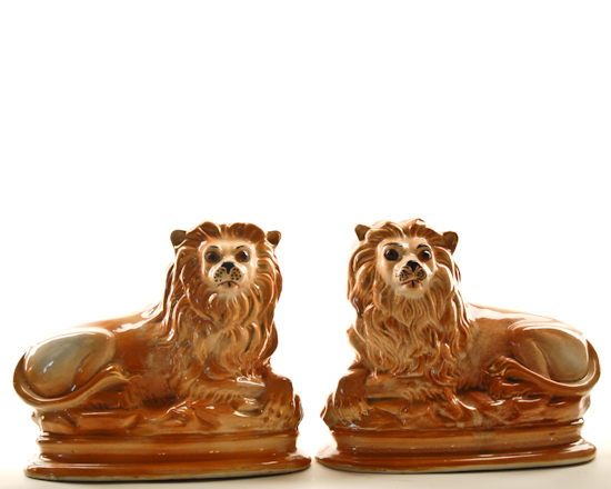 Appraisal: A Pair of Reclining Staffordshire Pottery Lions tawny with glass