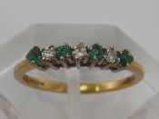 Appraisal: A carat yellow gold emerald and diamond seven stone ring