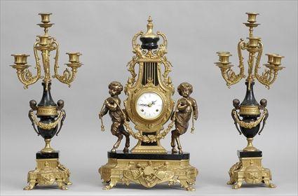 Appraisal: LOUIS XVI- STYLE GILT-METAL MOUNTED VEINED BLACK MARBLE THREE-PIECE CLOCK