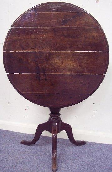 Appraisal: A Georgian oak table the circular top on a vase