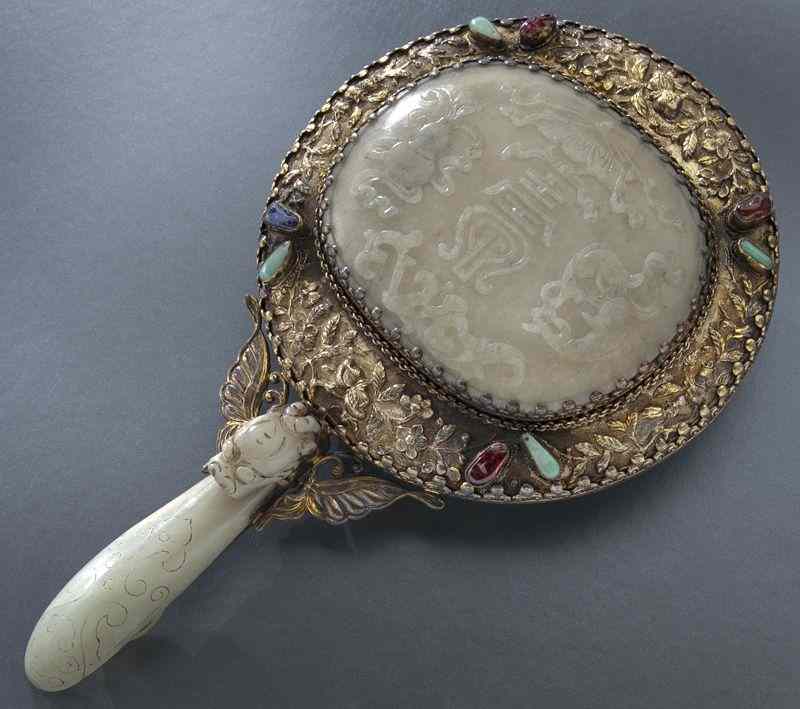 Appraisal: Chinese silver mounted jade mirrordepicting lucky symbols the handle a