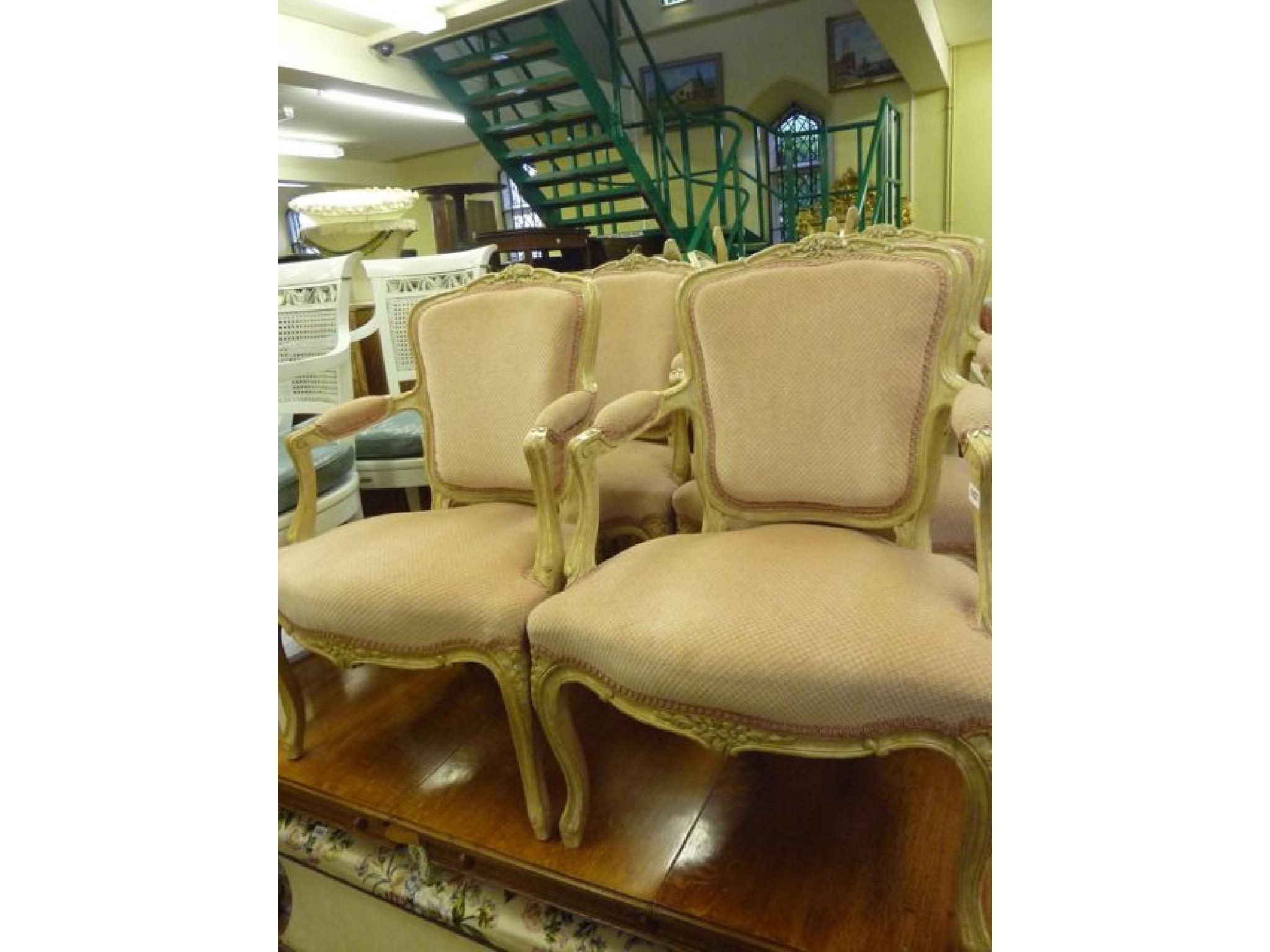 Appraisal: A set of four contemporary French open armchairs the beech