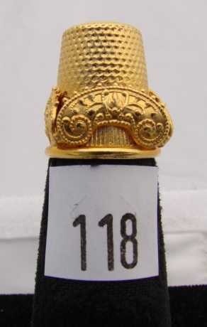 Appraisal: Gold tone thimble with leaf decorated band