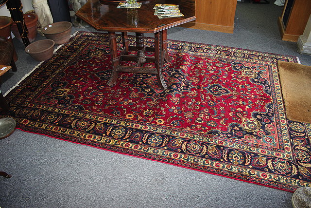 Appraisal: A TH CENTUARY WINE-GROUND CARPET central medallion with a foliate